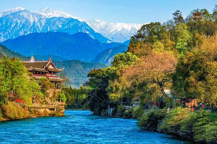 Rivière du système d’irrigation de Dujiangyan avec des montagnes enneigées en arrière-plan